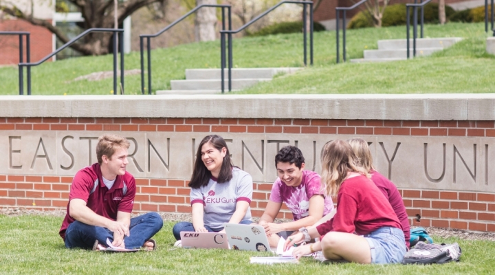 students sitting outside by Turner Gate